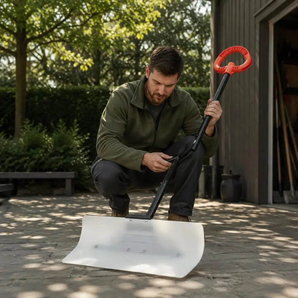 Man using snow pusher shovel with ergonomic handle in outdoor setting