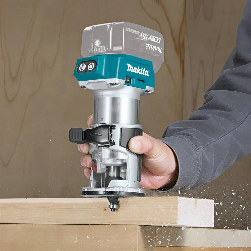 Makita DRT52 handheld router in use on woodwork in natural setting