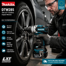 Makita DTW285 cordless impact wrench in workshop lifestyle shot, blue and black