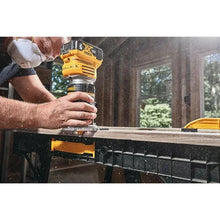 DEWALT DCW600B router in outdoor woodworking setting, handheld use