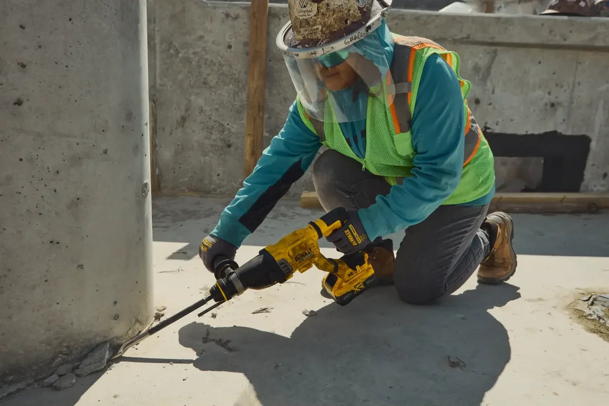 DEWALT DCH263 rotary hammer drilling on concrete lifestyle shot