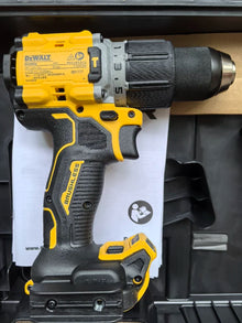 DEWALT DCD806 side view with user manual, yellow and black cordless hammer drill