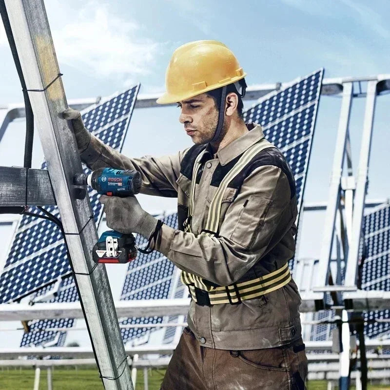 Bosch GDS 18V-400 impact wrench lifestyle shot held at construction site