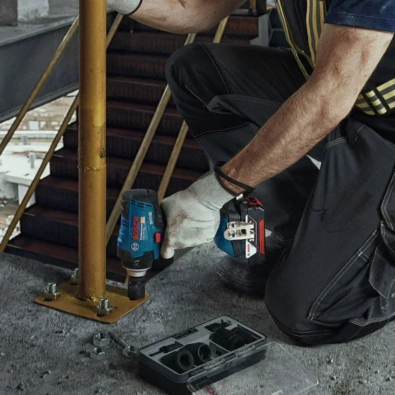 Bosch GDS 18V-400 cordless impact wrench lifestyle shot with worker on ladder
