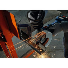 Orange cutting tool detail with sparks flying during metal cutting
