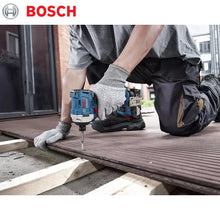 Bosch GDR 18V-215 lifestyle shot, gloved hand using impact driver on wood