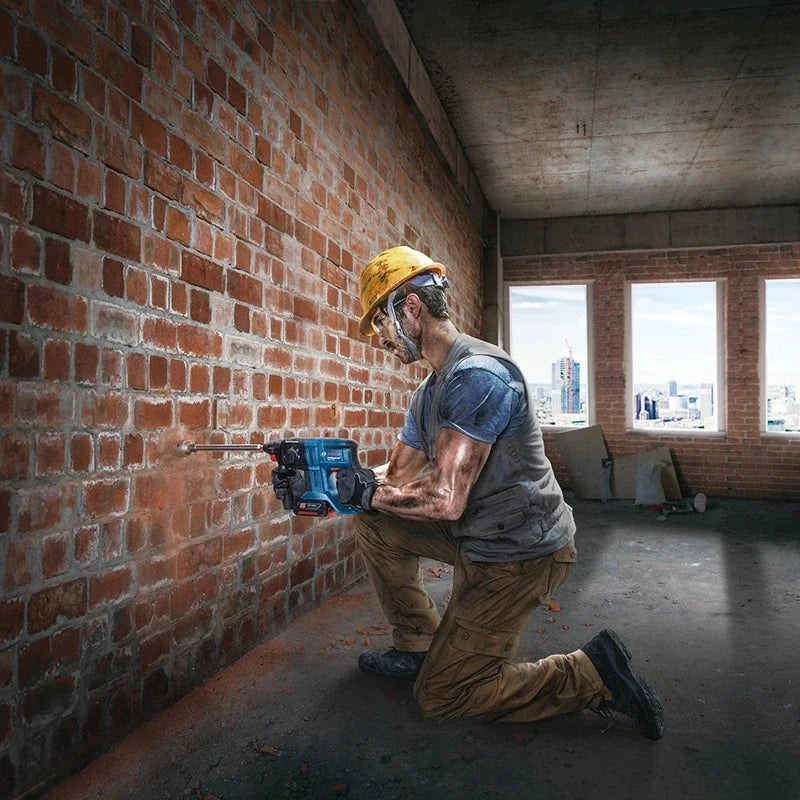 Bosch GBH 180-LI lifestyle shot with man kneeling by brick wall