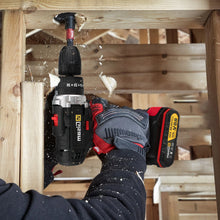 21V cordless impact drill lifestyle use during woodworking in black and red