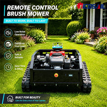 Remote control mower with tracked wheels in garden, black red green