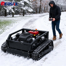 Remote control lawn mower in snowy setting, tracked wheels, black red white
