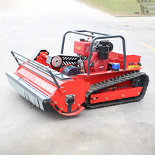 Red compact tractor side view, tracked wheels and front blade