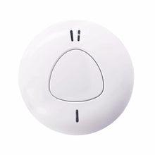 Close-up detail of minimalist smoke detector, white body, single button