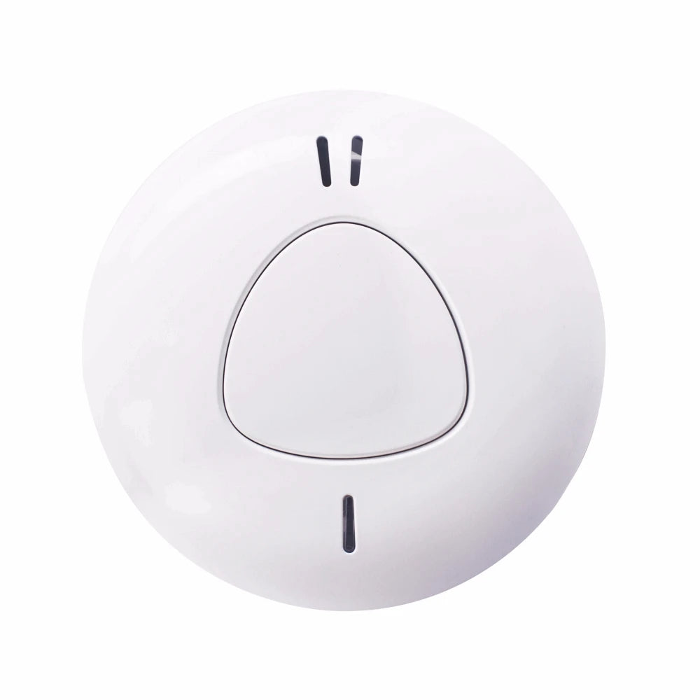 Close-up detail of minimalist smoke detector, white body, single button