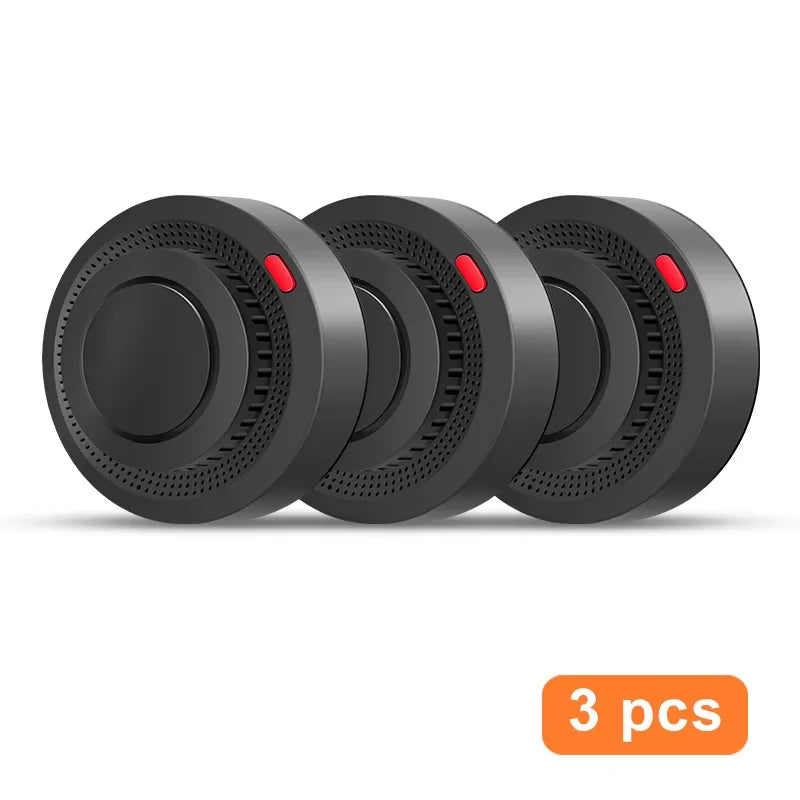 Tuya Smart WiFi Smoke Sensor front view, set of three black speakers with red accents