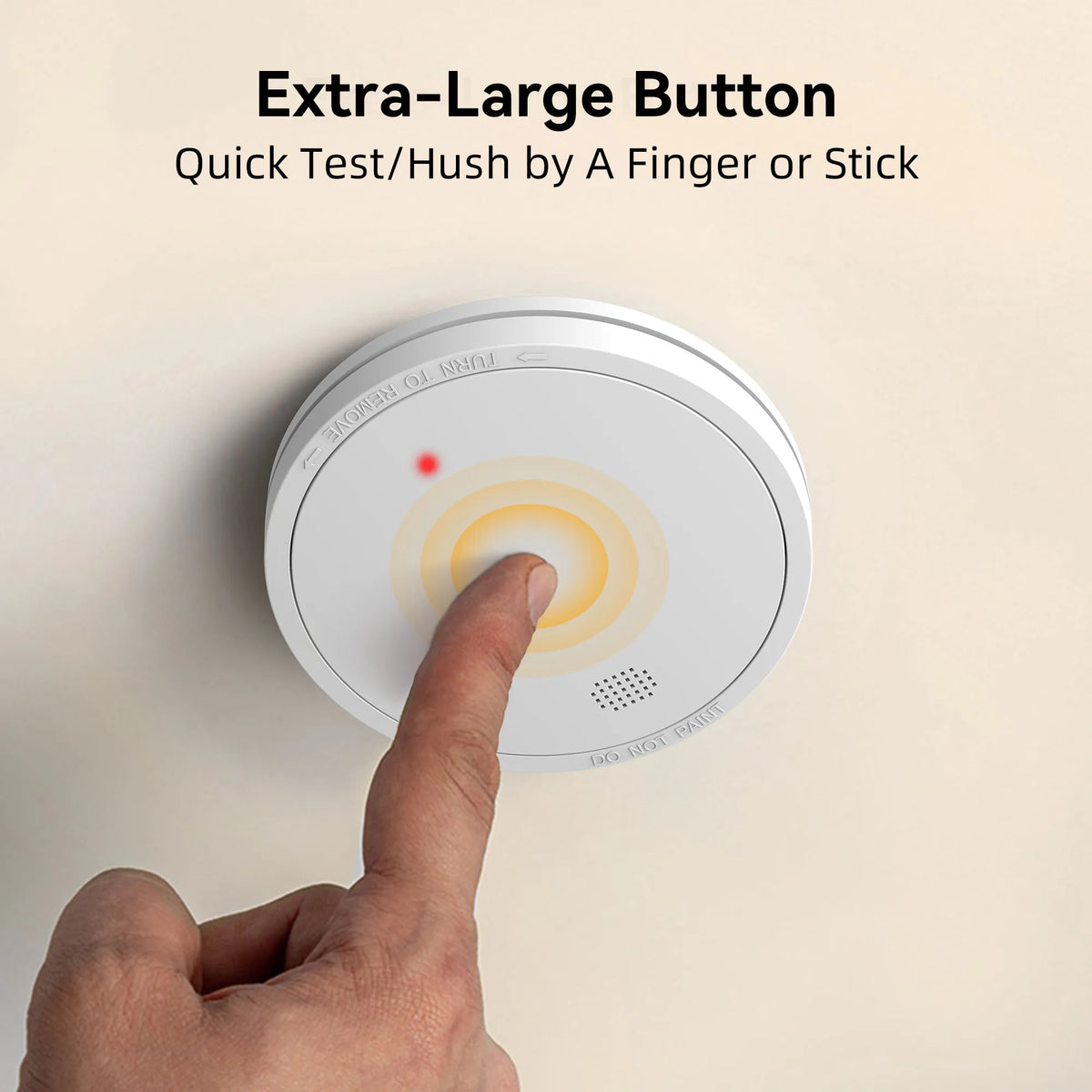 Smoke alarm close-up with large button, white yellow red on solid background