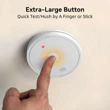 Smoke alarm close-up with large button, white yellow red on solid background