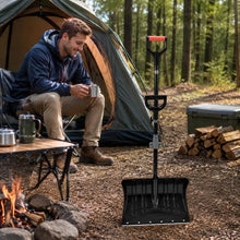 18 inch snow shovel near a campfire with a tent in background