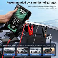 Car jump starter in black and green with charging indicator, lifestyle shot.