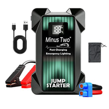 Car jump starter in black and green with USB charging, detail shot.