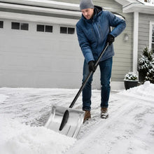 Aluminum alloy snow shovel with silver blade in use by a man outdoors.