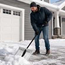 Aluminum alloy snow shovel with silver blade in use by a man outdoors.
