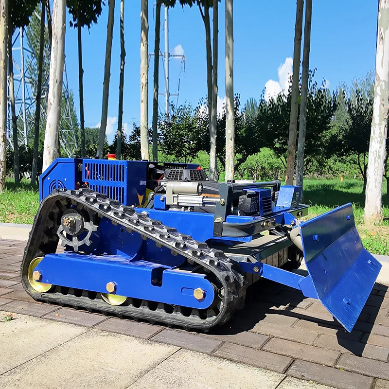 Back view of the blue tracked snow removal machine with front blade