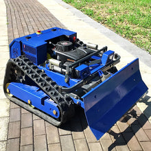 Side view of the blue mini bulldozer with tracked wheels and front blade