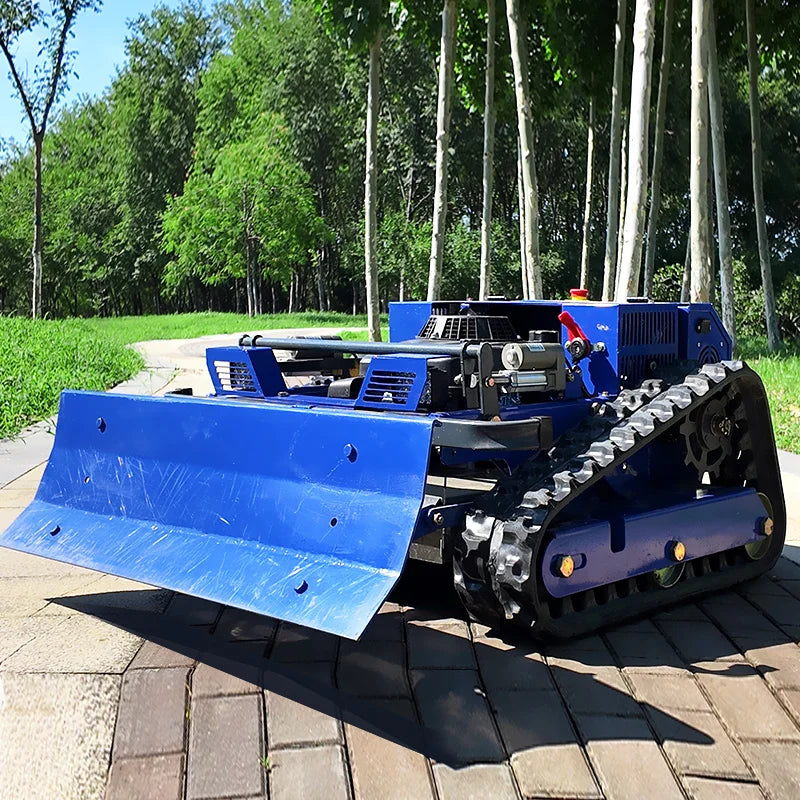 Side view of the blue tracked snow removal machine with front blade
