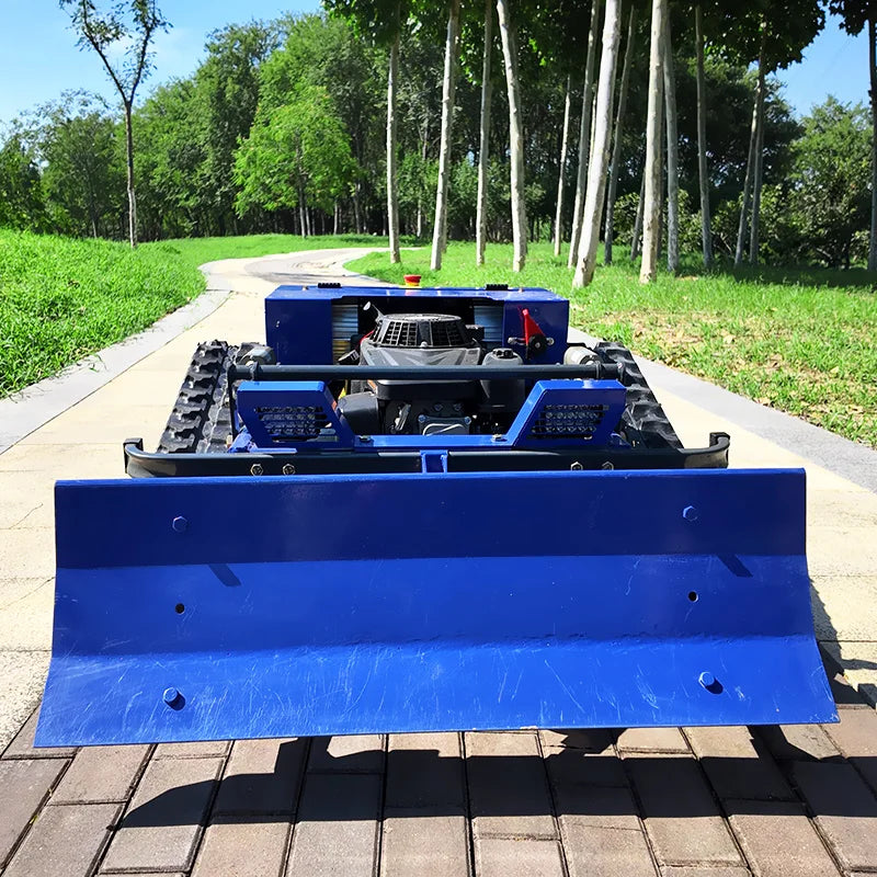 Side view of the blue tracked snow removal machine with front blade