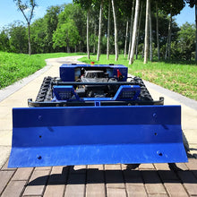 Side view of the blue tracked snow removal machine with front blade