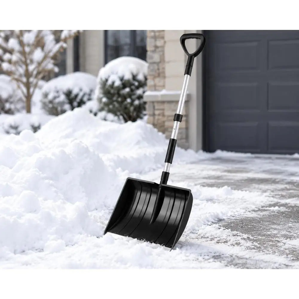 Lightweight and portable snow shovel with D-grip handle in black, lifestyle shot.
