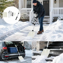 Man shoveling snow with a black and white snow shovel in a natural setting.