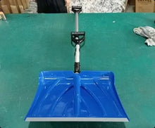 Front view of a blue shovel with a long handle and flat blade on a solid color background.